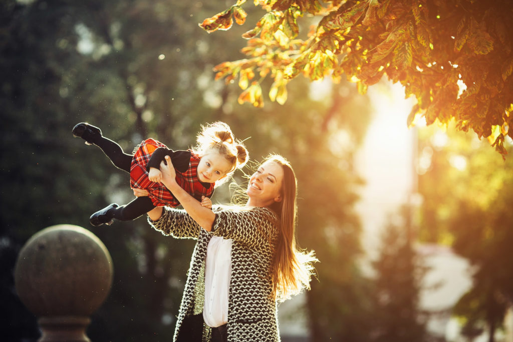 mother and little daughter playing in a park PP9AENH