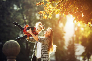 mother and little daughter playing in a park PP9AENH