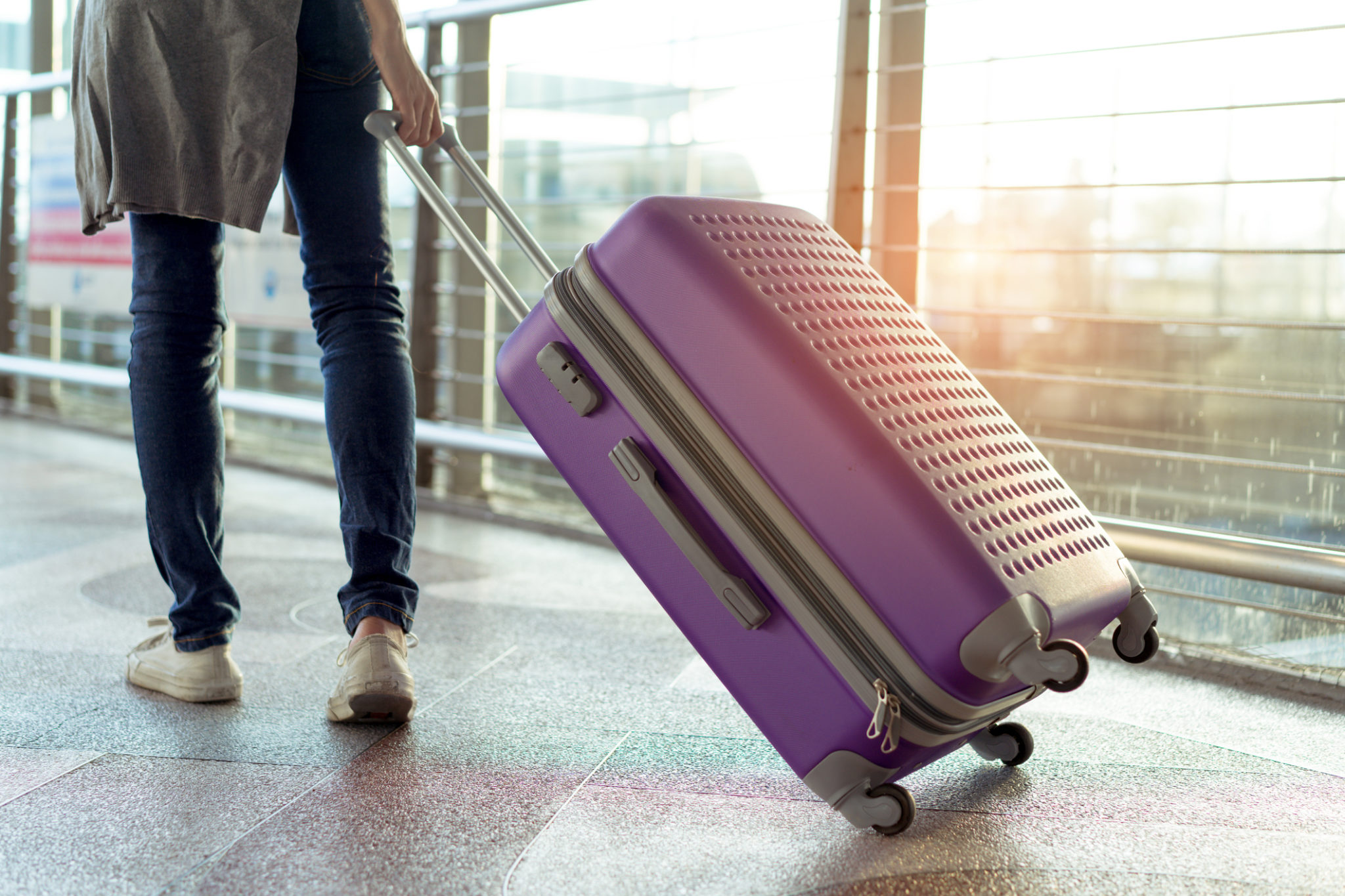 Young girl traveler walking with carrying hold suitcase luggage and passenger for tour travel booking ticket flight in airport international vacation time in holiday rest and relaxation. Young girl traveler walking with carrying hold suitcase luggage and passenger for tour travel booking ticket flight in airport international vacation time in holiday rest and relaxation.
